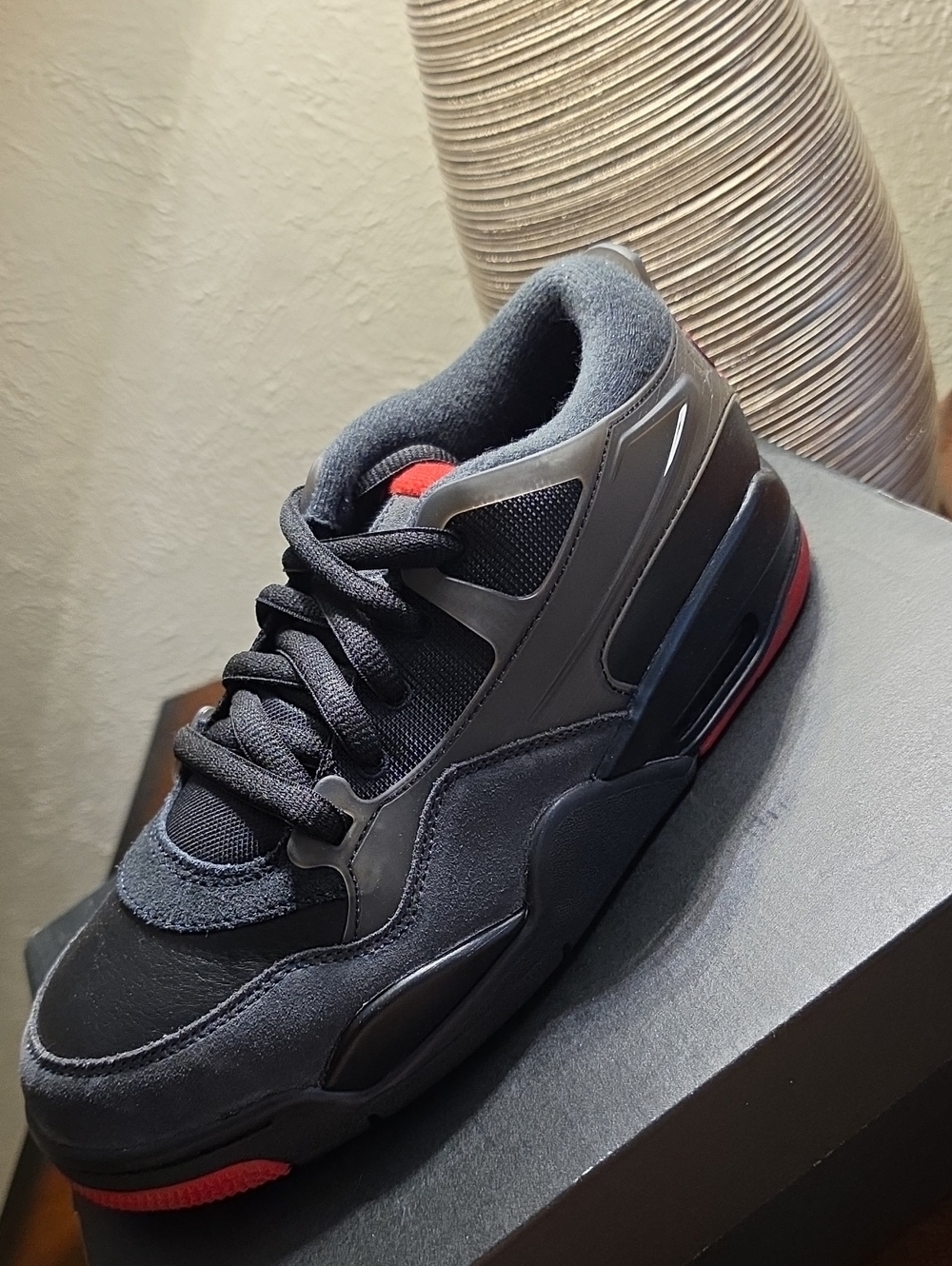 Air Jordan 4 RM Youth Athletic Shoe in Black with Red Accents 7Y